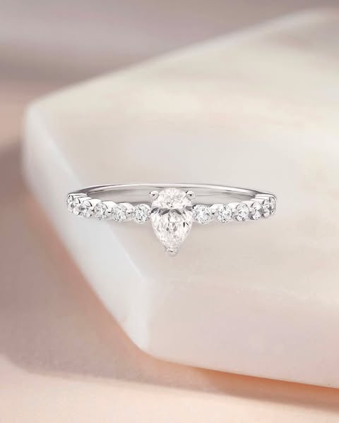 Beaverbrooks the Jewellers ad: A pear-shaped diamond meets a scalloped diamond band ✨ And there’s even more to love: you can now get an extra 10% off sale diamond rings fo